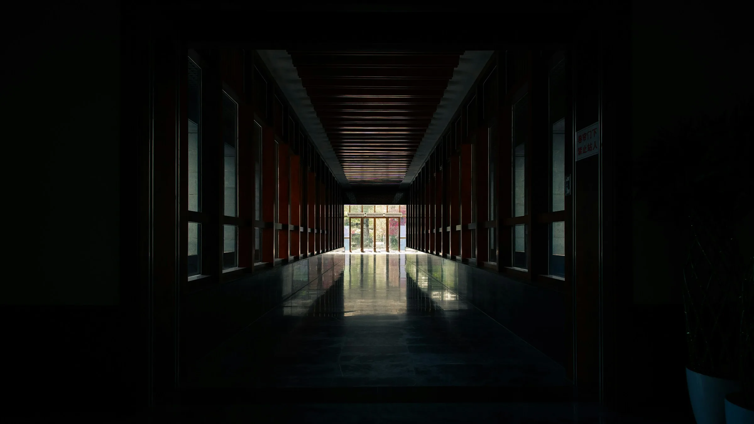 Illustrative wallpaper: a corridor opening onto daylight